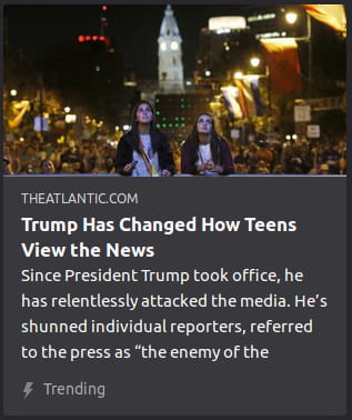 By the Atlantic. Photo o’ 2 teens standing in front o’ a crowd in a nightlit city.